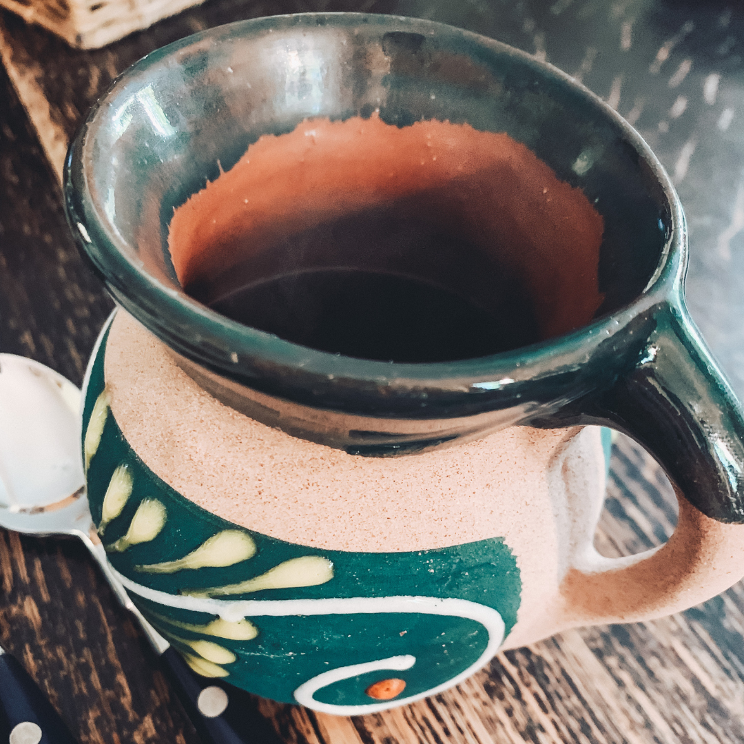closeup picture of a clay mug with steaming Mexican coffee